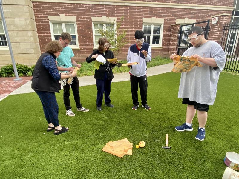 Marveling over the contents in the time capsule are (l-r) teacher Alyssa Simon and students Jacob Schumaier, Shane Lammey, Kevin Cespedes and Thomas Kramer. ELLEN DRISCOLL PHOTO